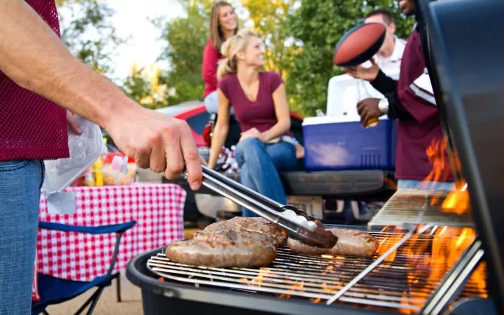 Sausages on a grill at a tailgate party