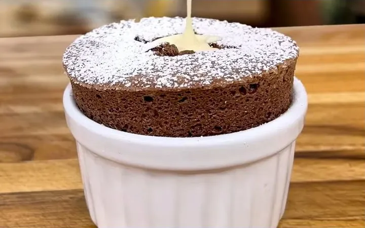 A chocolate soufflé with cream poured in the center
