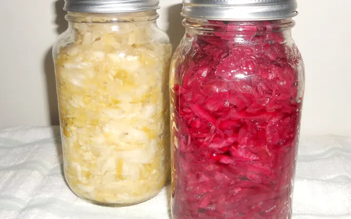 Two jars of homemade sauerkraut, one white and one red
