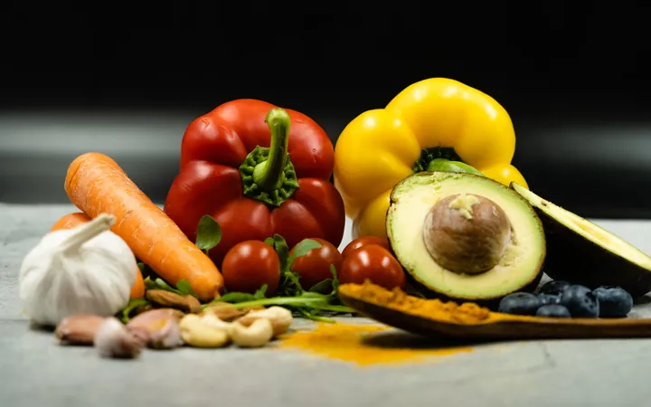 Fresh vegetables, avocado and spices on a table