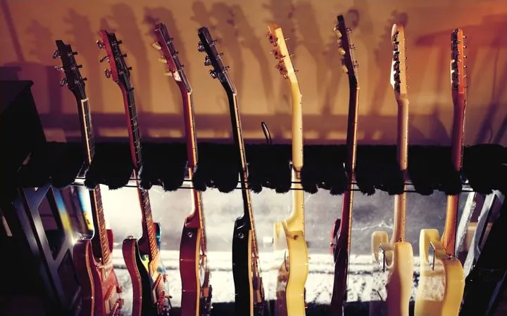A row of electric guitars on a stand in a recording studio