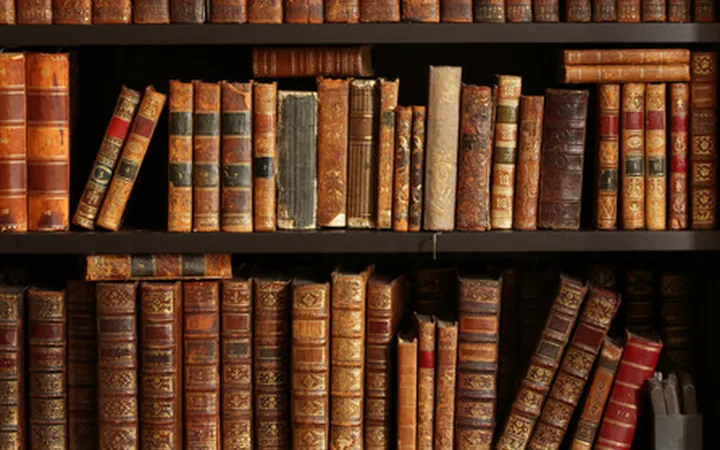 Shelves of antique leather-bound books