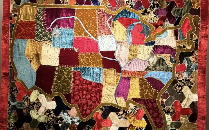 A velvet patchwork quilt shaped like a map of the United States